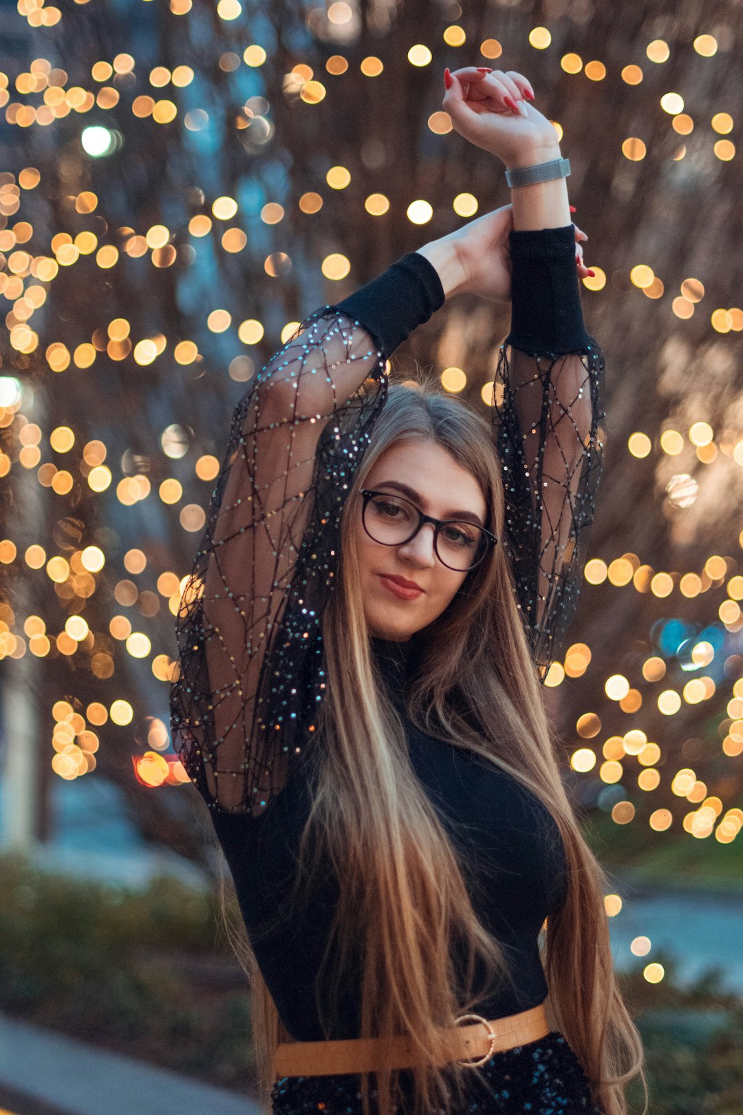 woman in black long sleeve shirt with brown string lights on her head