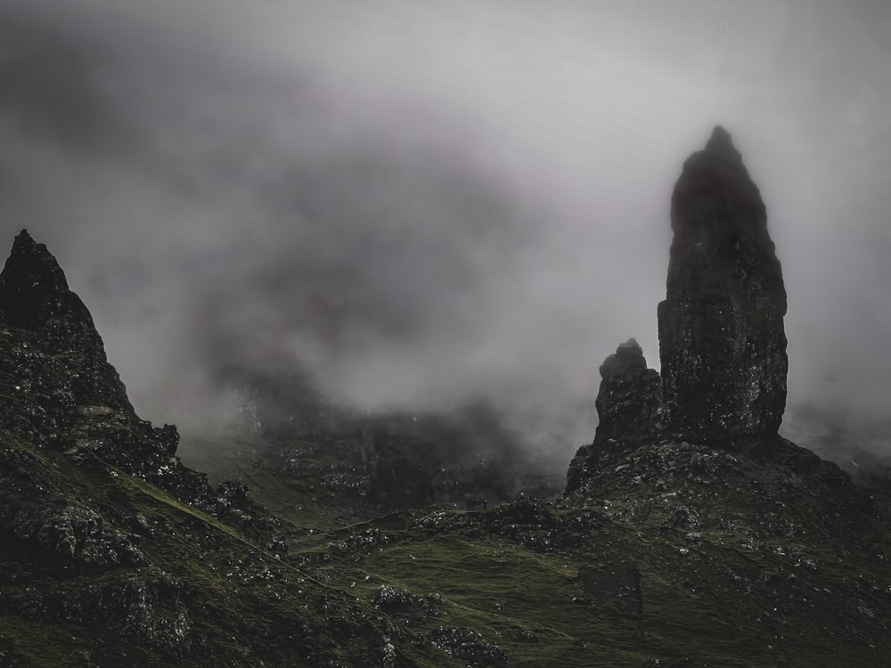 green grass covered mountain under white clouds