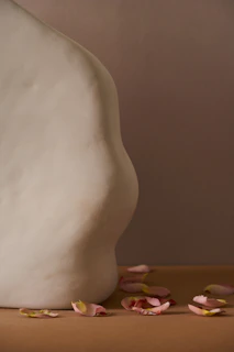 A stunning close-up of a pastel-painted sculpture awarded the Asho prize, set against a minimalist white gallery wall.