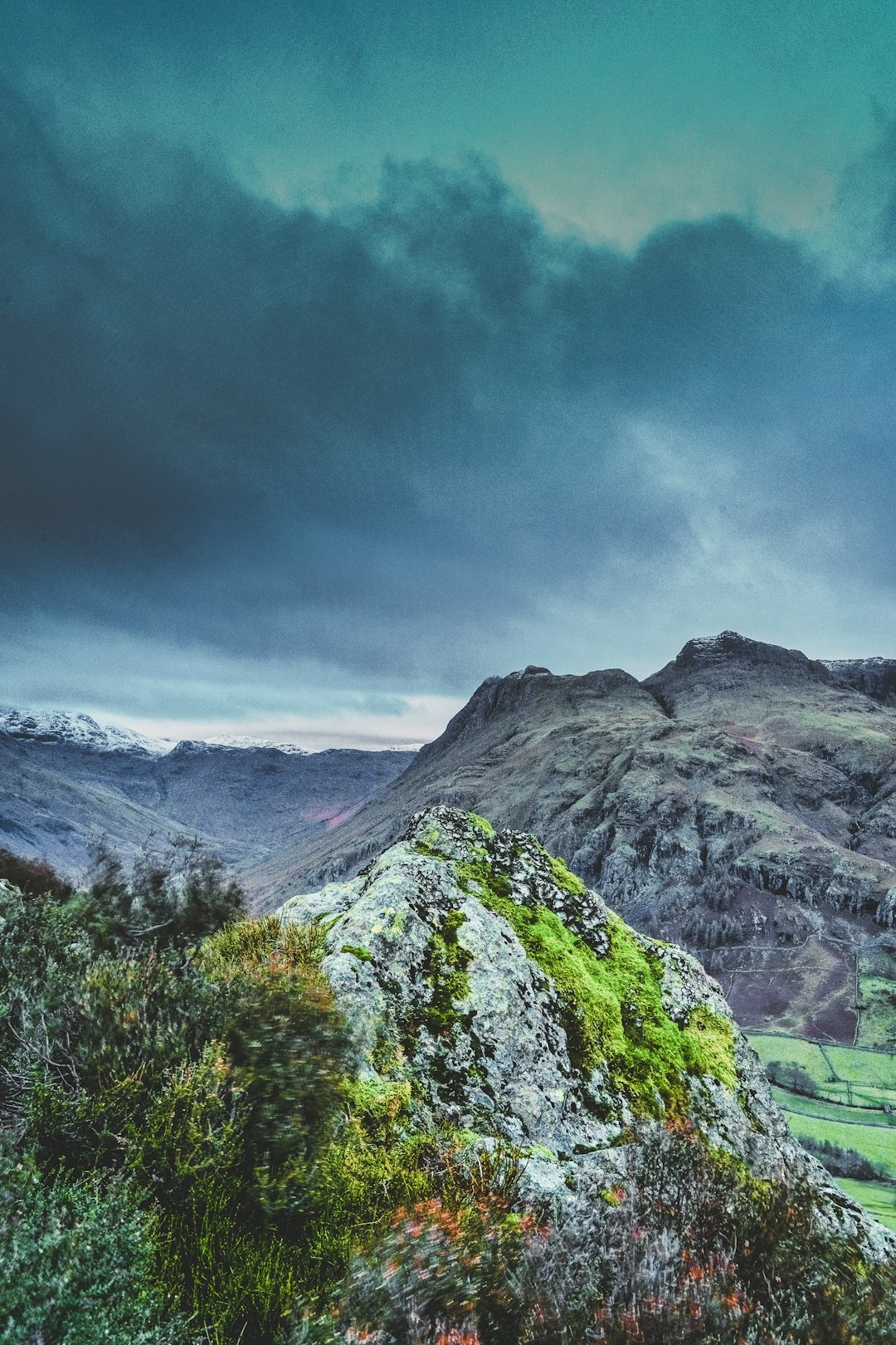 green and gray mountain under white clouds and blue sky during daytime