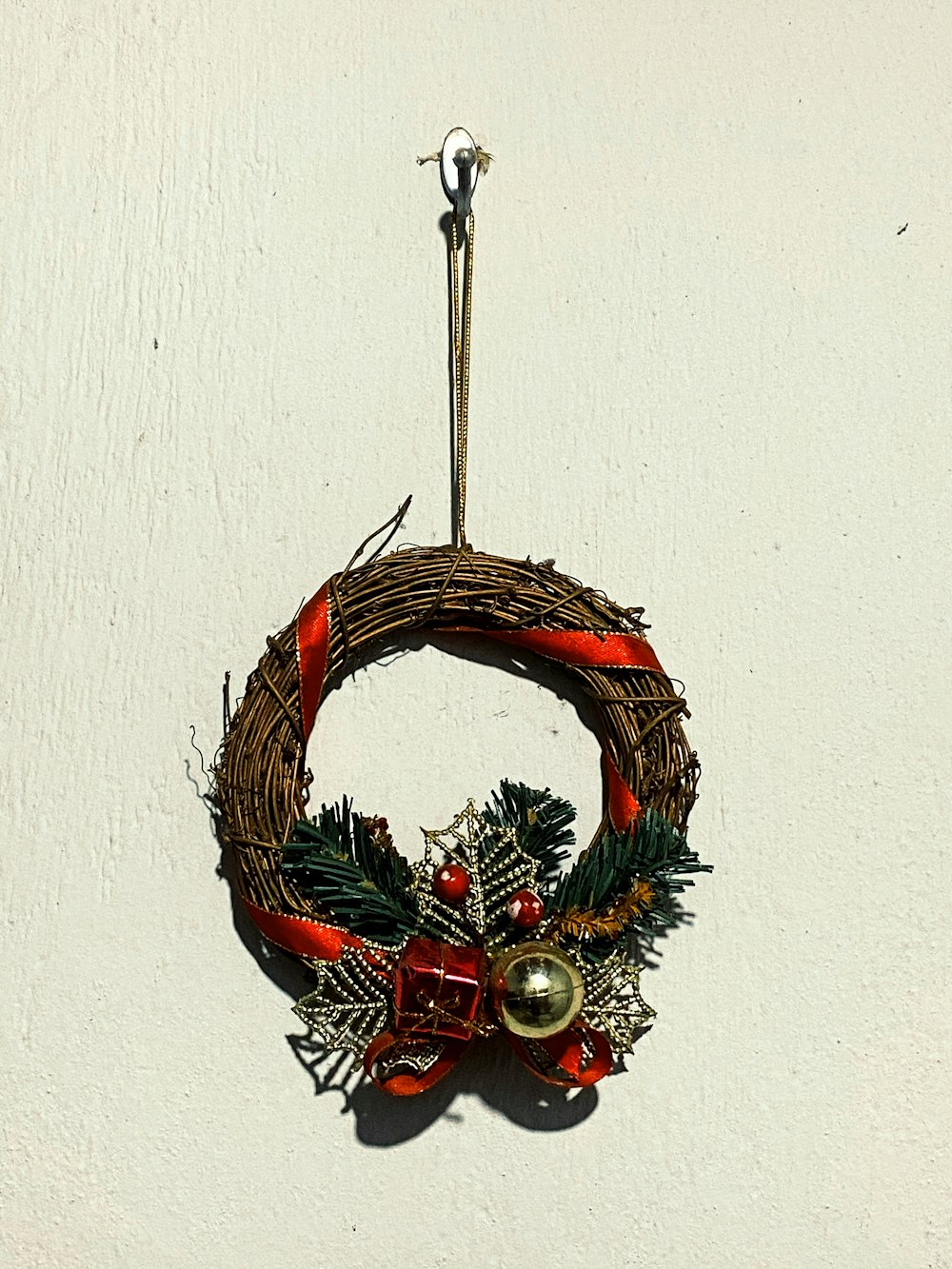 brown and green wreath with red and gold baubles