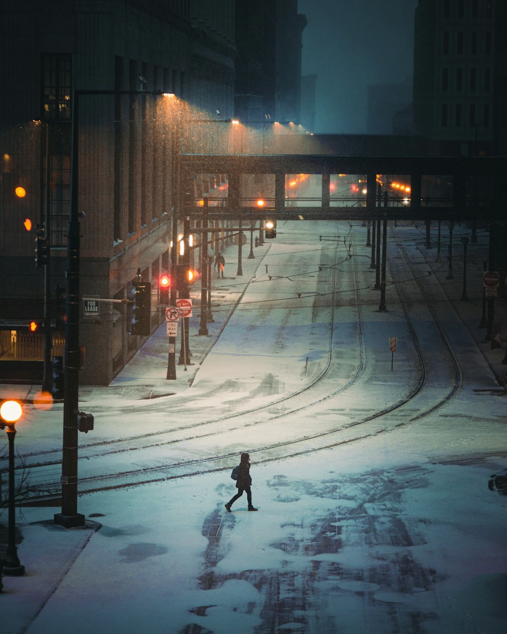 man in black jacket walking on street during night time