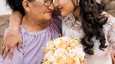 woman in pink dress holding bouquet of flowers