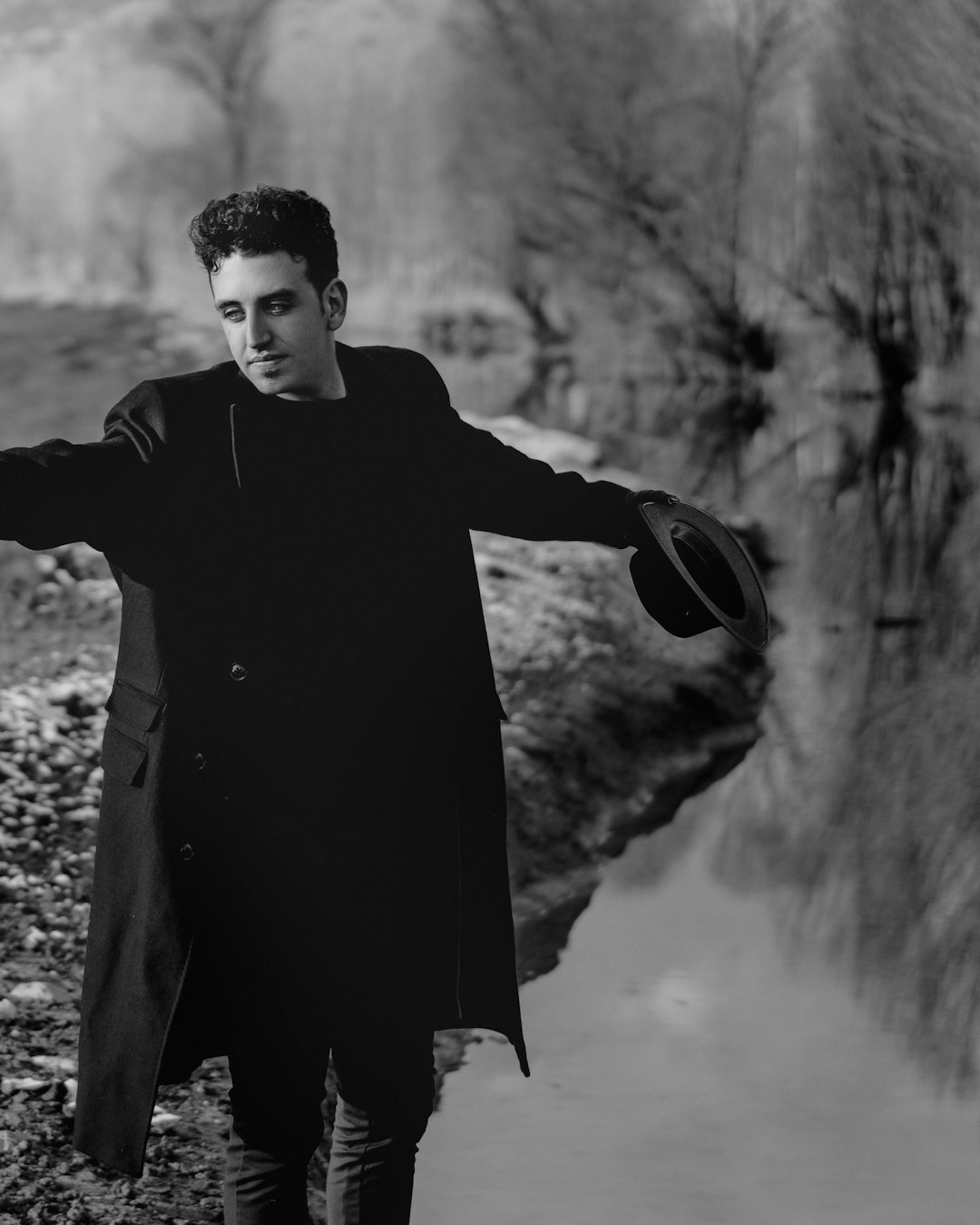 man in black coat standing on snow covered ground