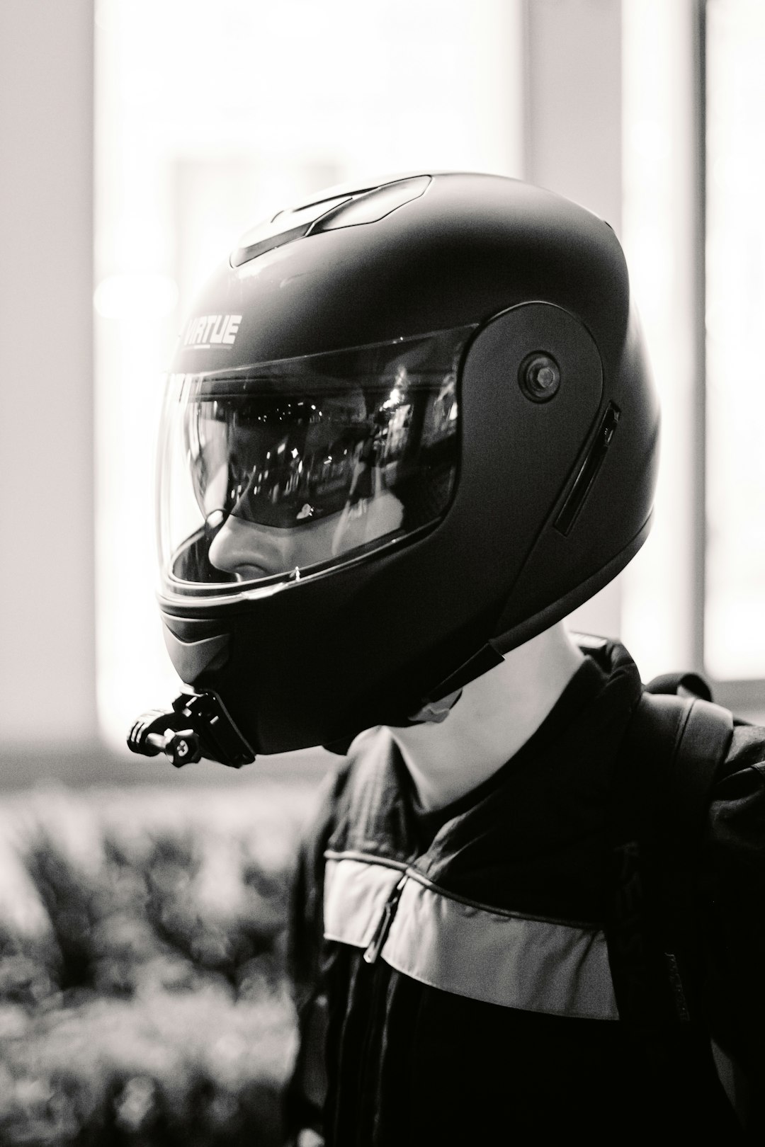 grayscale photo of man wearing helmet