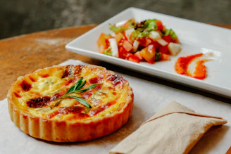 pizza with green leaf on white ceramic tray