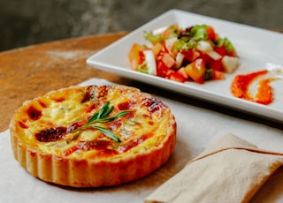 pizza with green leaf on white ceramic tray