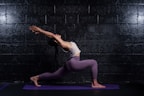 woman in gray tank top and leggings doing yoga