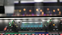 Close-up of professional audio mixing console with colorful lights