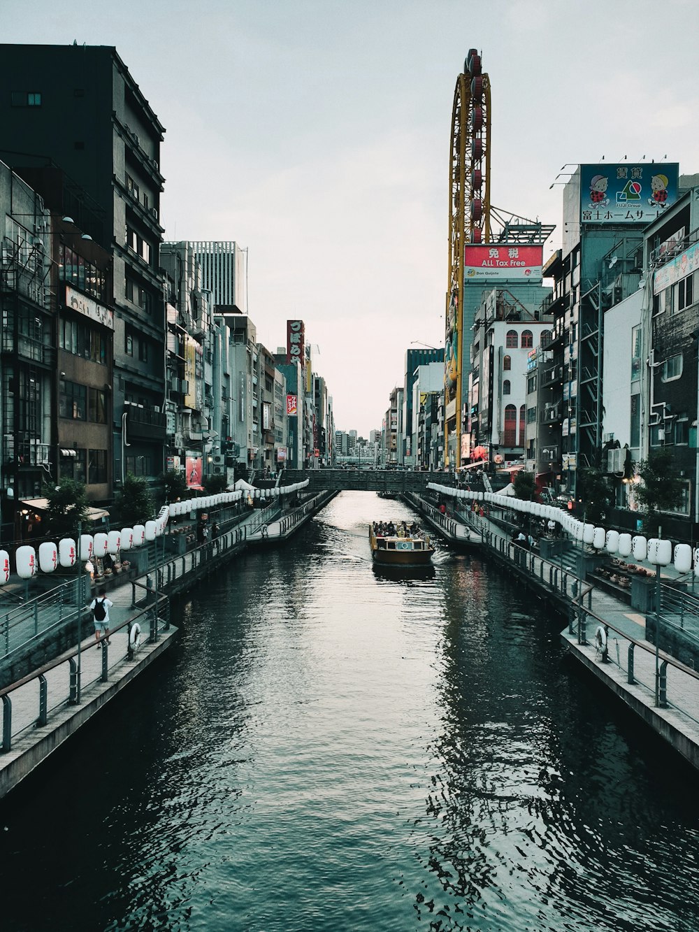 boat on river between buildings during daytime