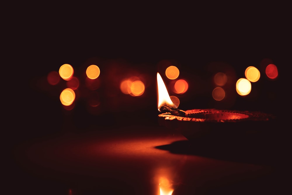 bokeh photography of lighted candle