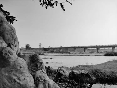 Minimalist black and white photo of a river flowing through Brazilian natural landscape.