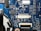 A detailed view of a blue printed circuit board with various electronic components such as capacitors, resistors, and integrated circuits. The board features visible traces and connections, along with labeled components and reference numbers.
