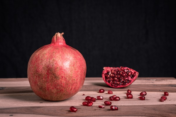 Red round fruit on black surface