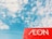 A clear blue sky with scattered white clouds provides a backdrop for a prominent red sign featuring the word 'AEON' in white letters.