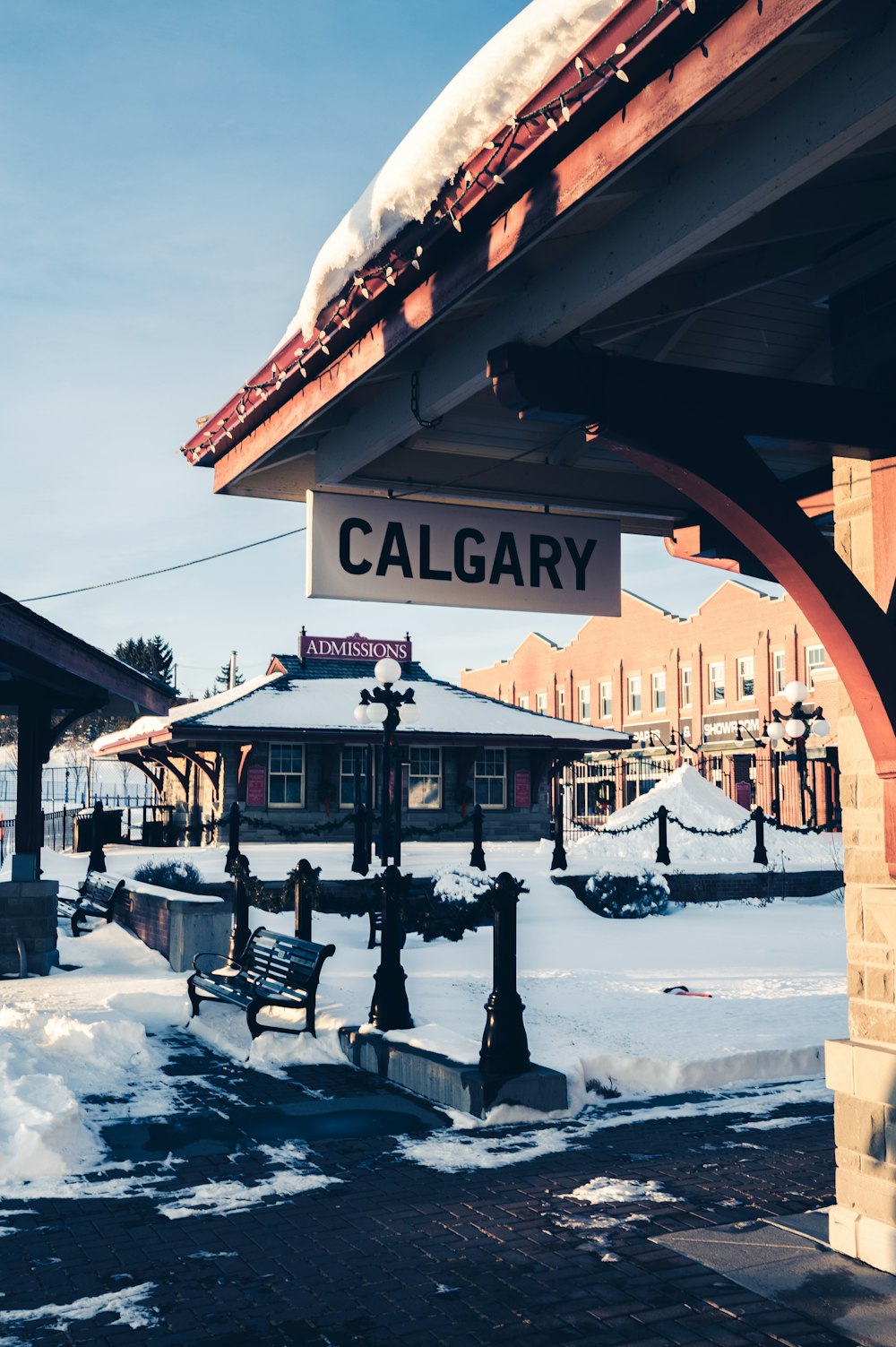 brown wooden bench on snow covered ground