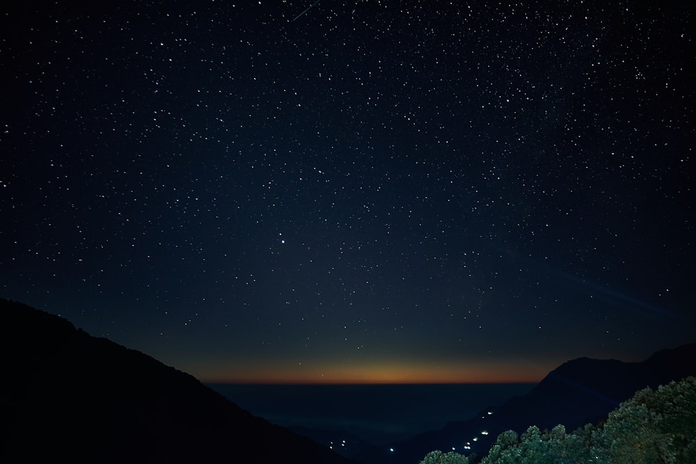 silhouette of mountain during night time