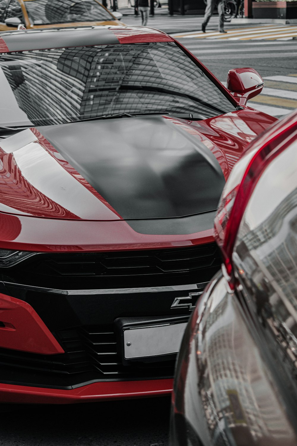 red and black car in front of building