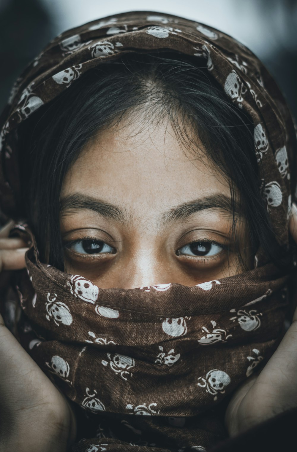 woman with brown and white floral scarf