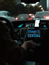 person holding iphone 6 taking photo of cars on road during night time