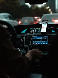person holding iphone 6 taking photo of cars on road during night time