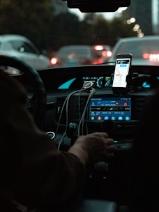person holding iphone 6 taking photo of cars on road during night time