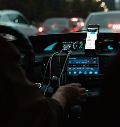 person holding iphone 6 taking photo of cars on road during night time