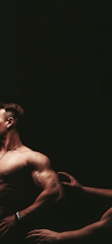 topless man with black background