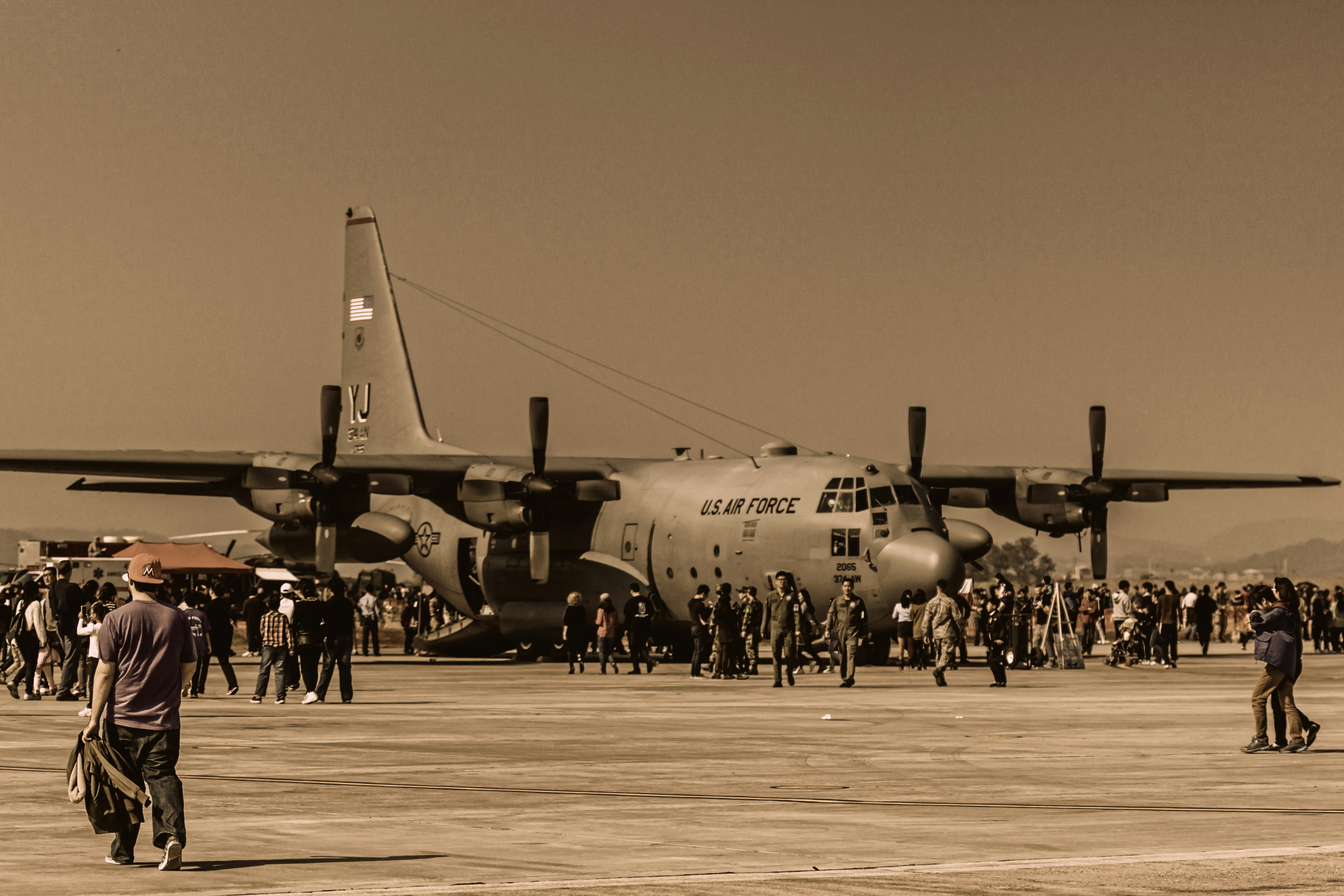 black and white jet plane on gray field during daytime, 