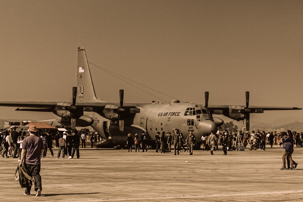 black and white jet plane on gray field during daytime