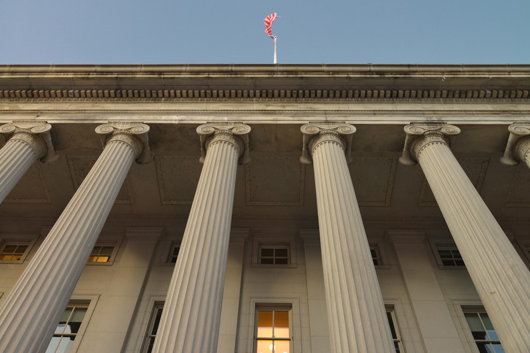 white concrete building with flag on top