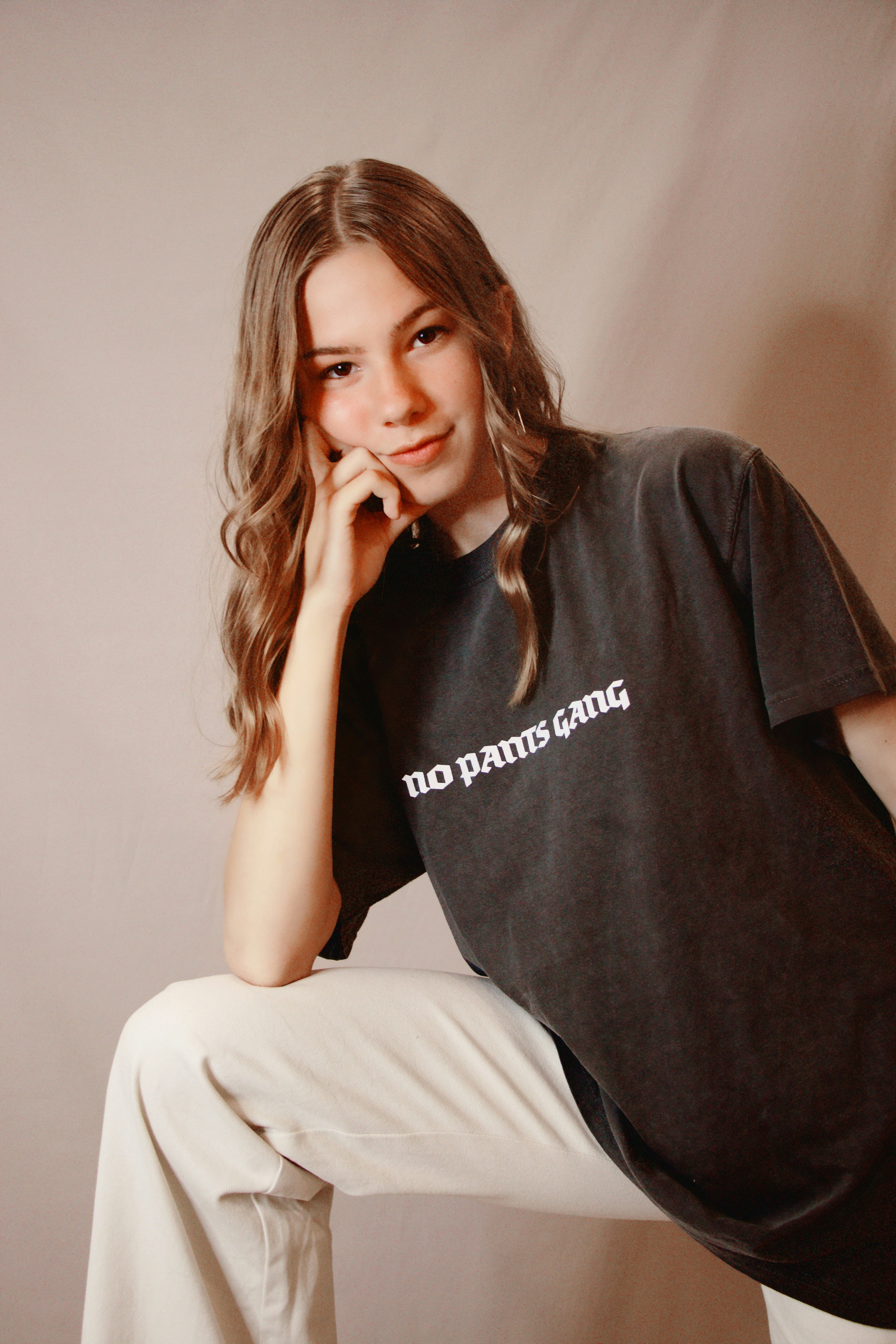 woman in black polo shirt sitting on bed