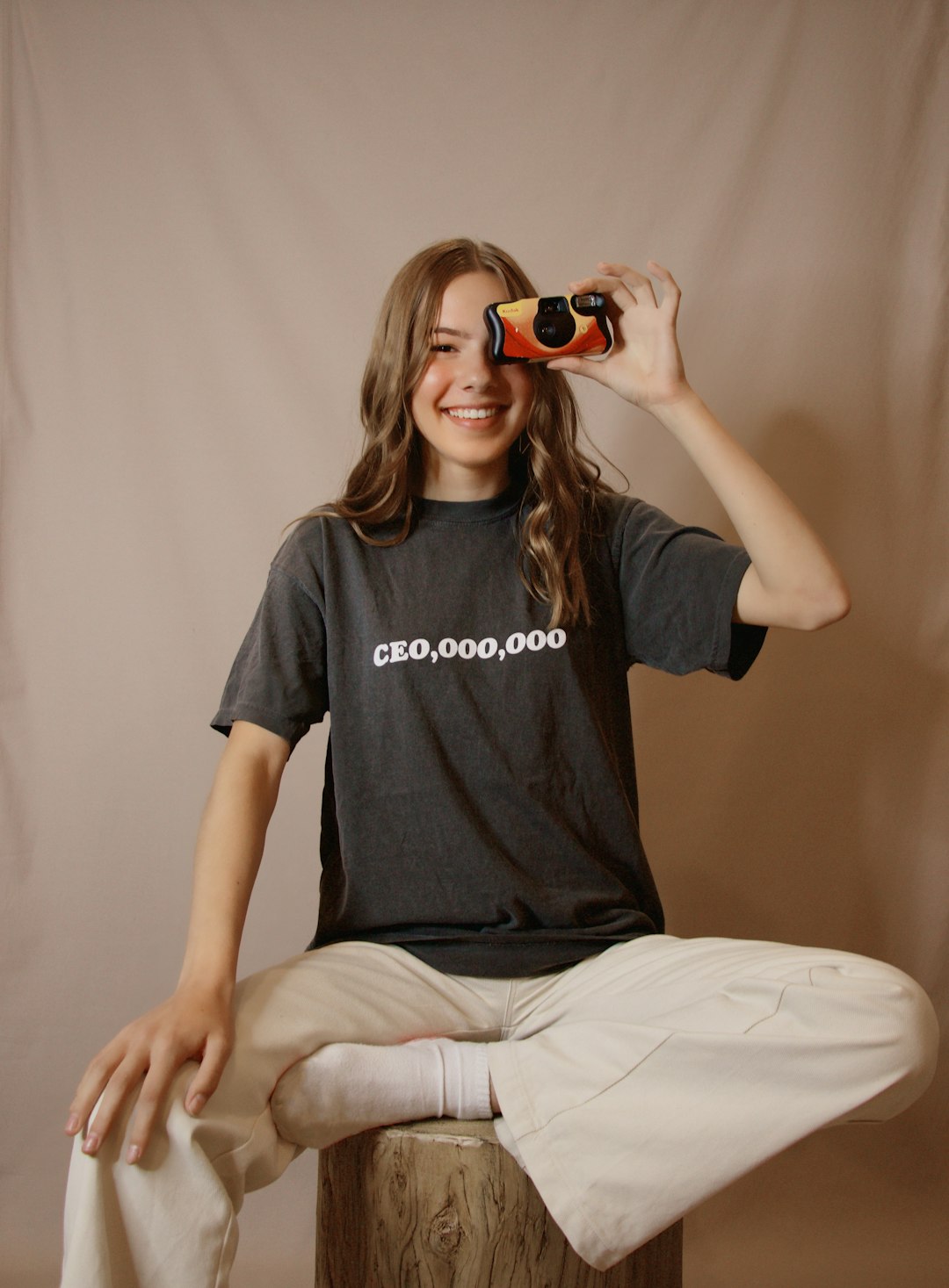 woman in black crew neck t-shirt and white pants sitting on bed