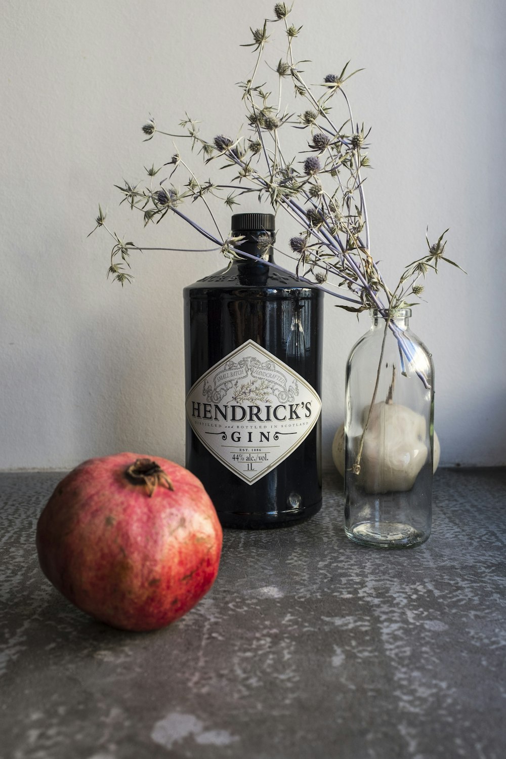 red apple beside clear glass bottle