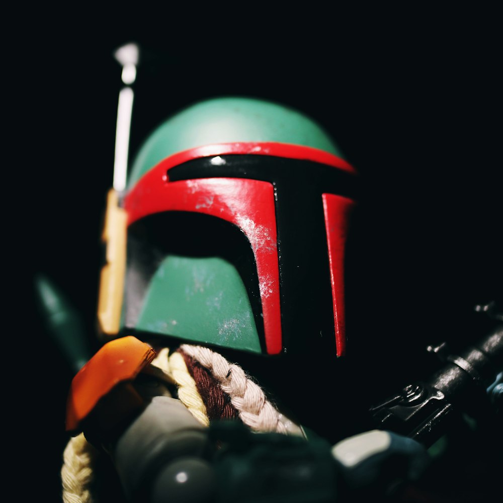 red and black helmet on black and white textile