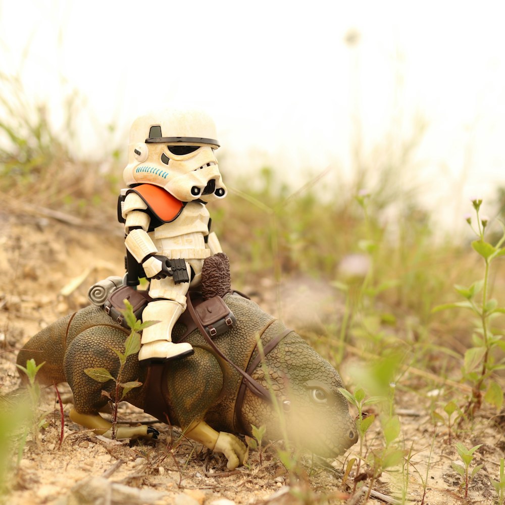 two green frog plush toys on brown soil