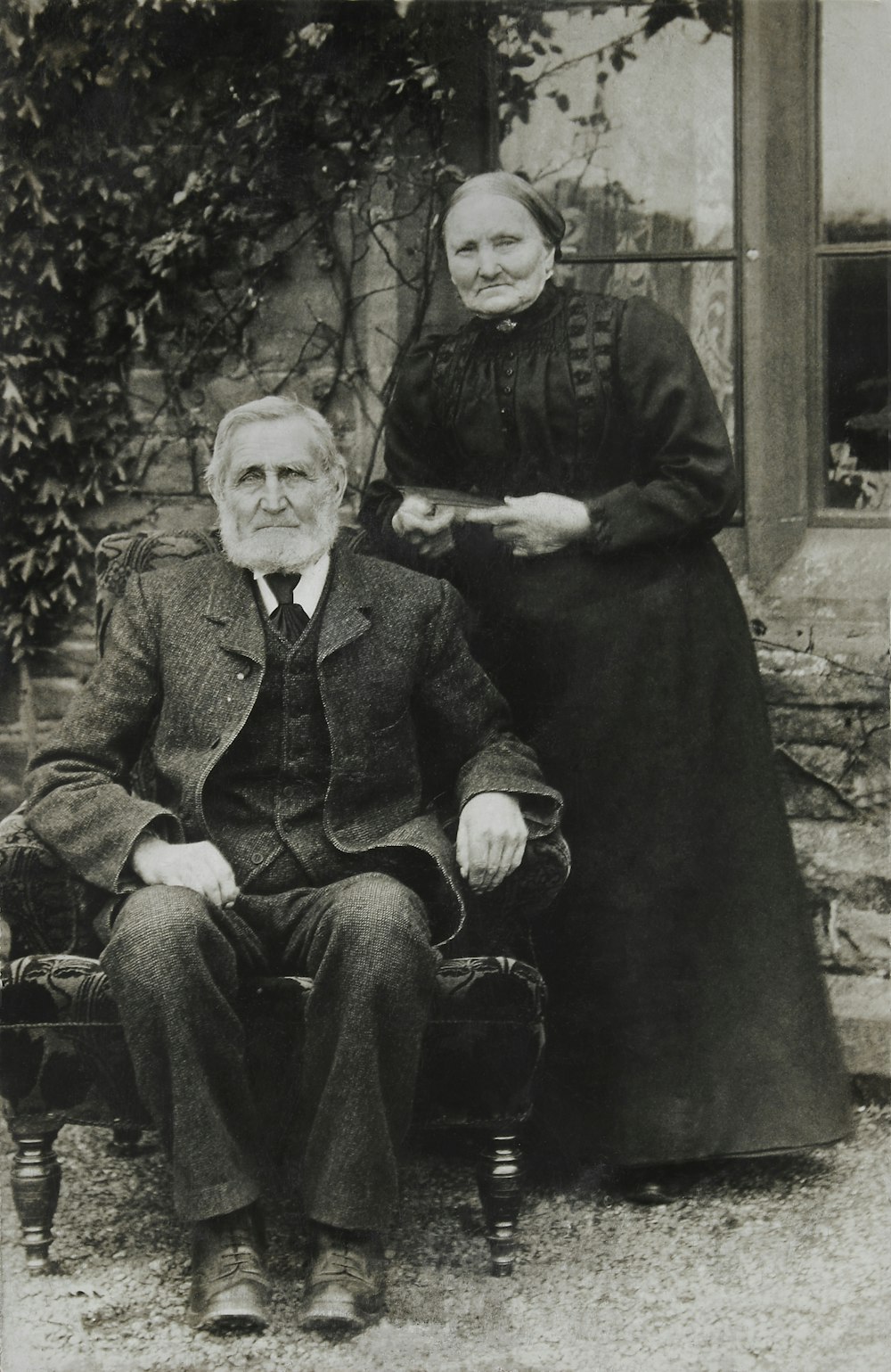 man and woman sitting on bench