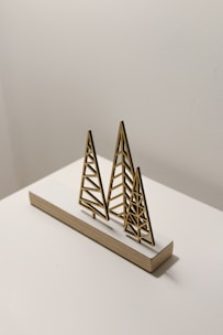 brown wooden pyramid on white table