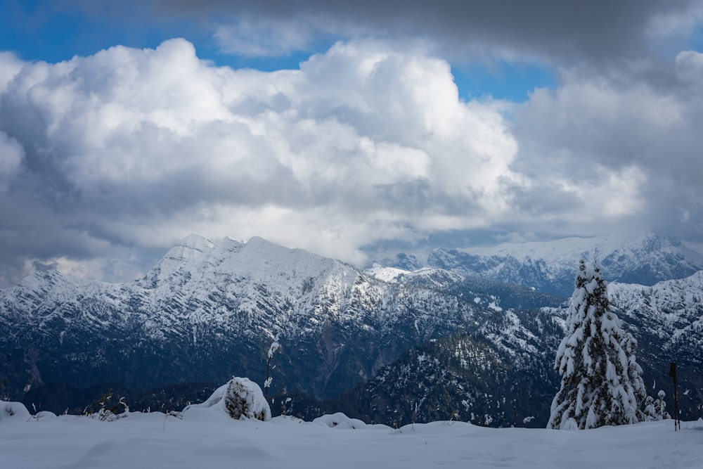 snow covered mountain under cloudy sky during daytime