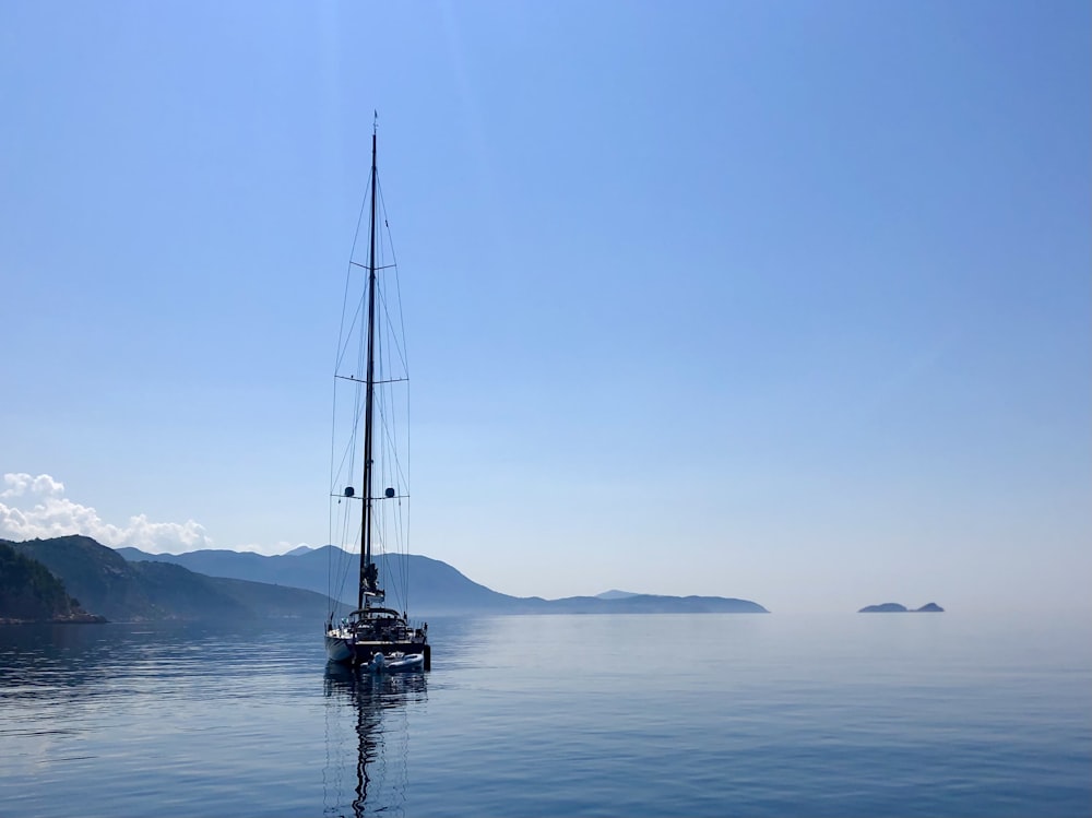 sailboat on sea under blue sky during daytime