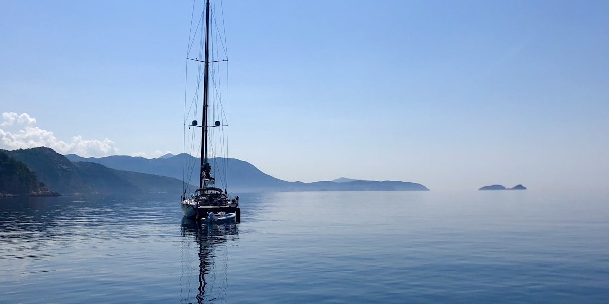 sailboat on sea under blue sky during daytime