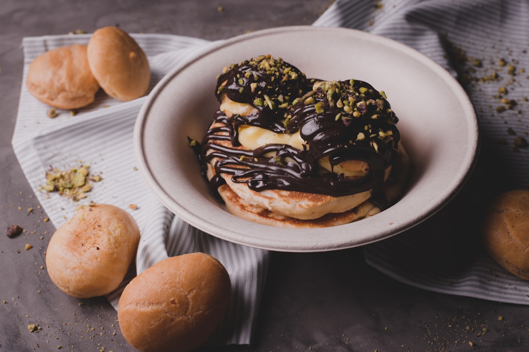 brown and black donut on white ceramic plate