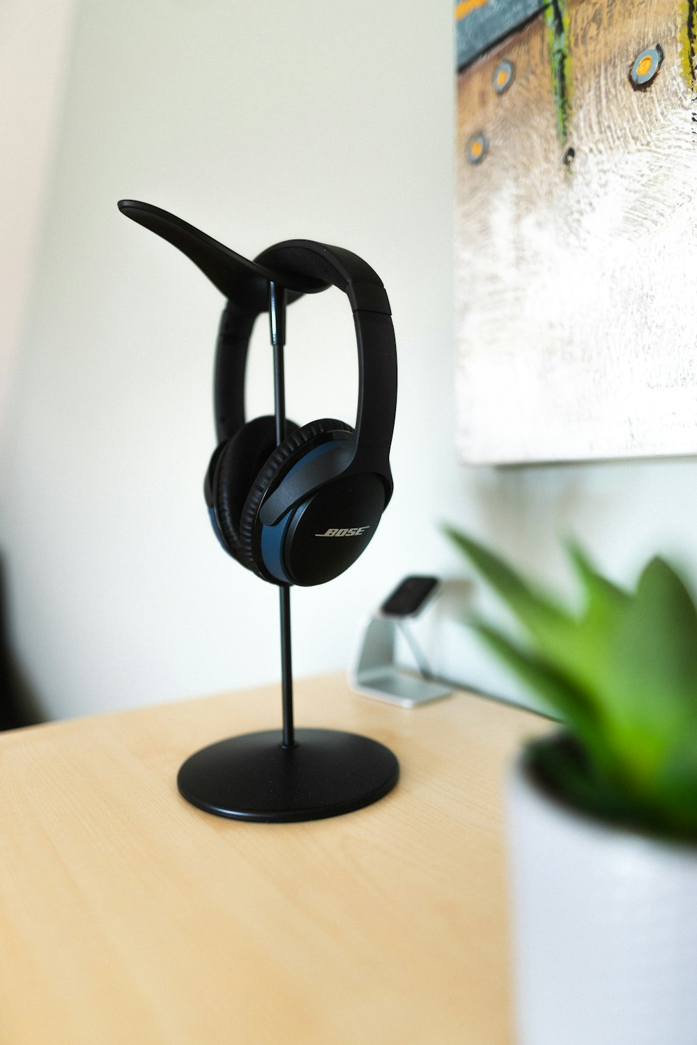 black and gray corded headphones on brown wooden table