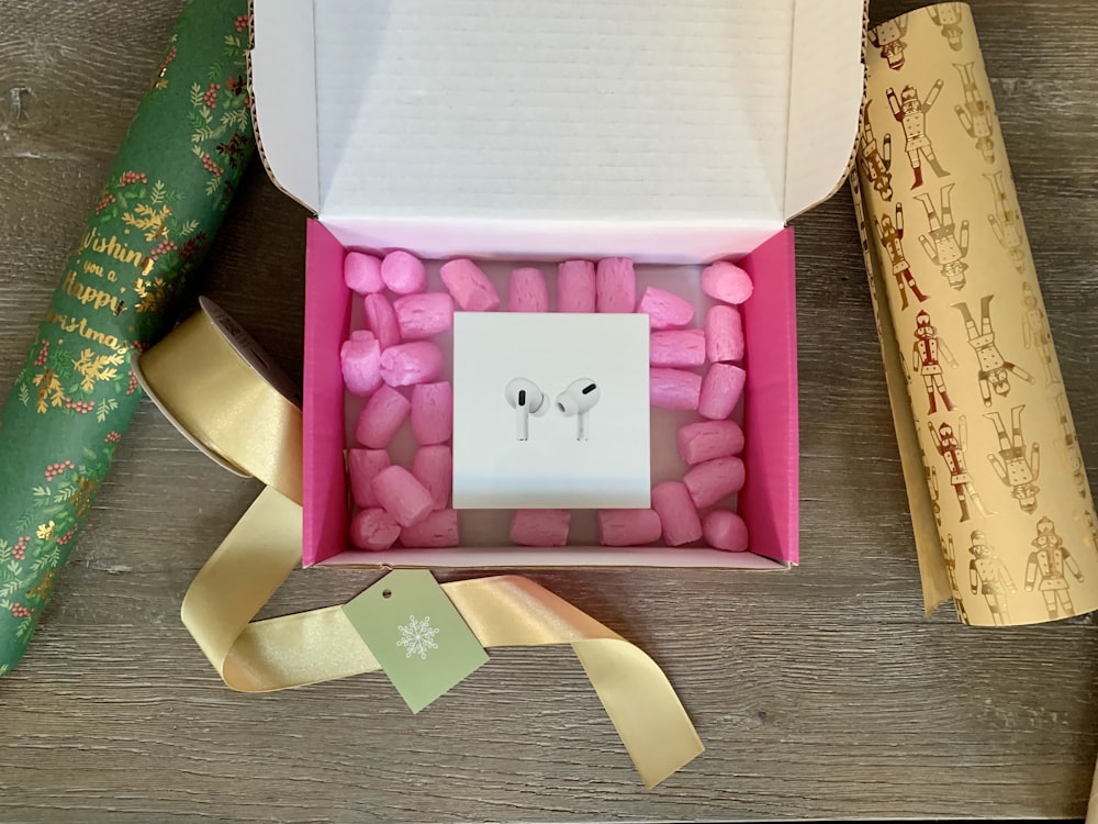 white and pink box with white printer paper