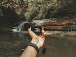 André capturing photos of a breathtaking waterfall.