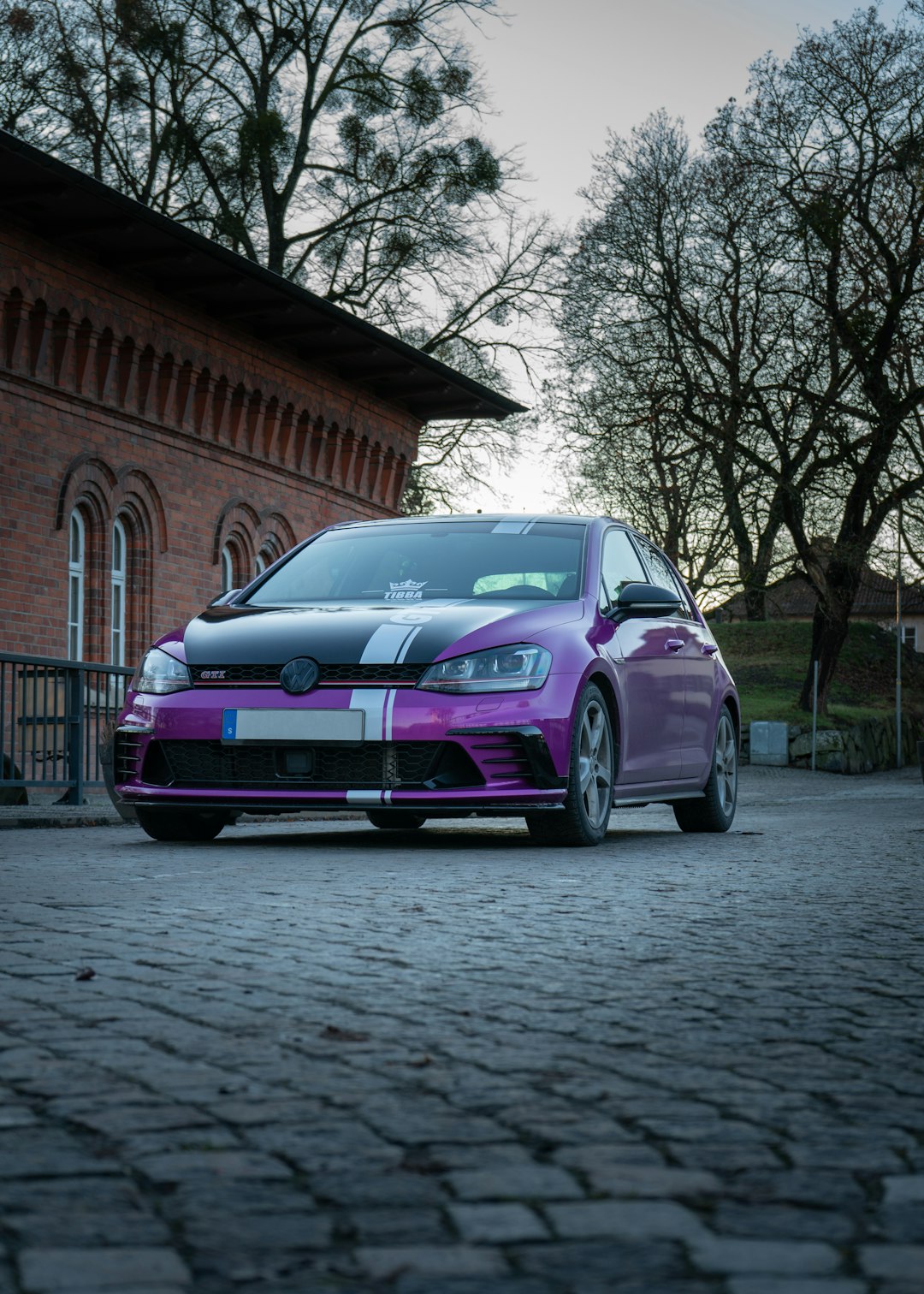 purple bmw m 3 parked on sidewalk during daytime