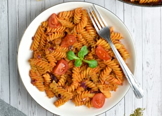 pasta with sauce on white ceramic plate