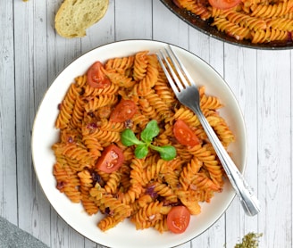 pasta with sauce on white ceramic plate