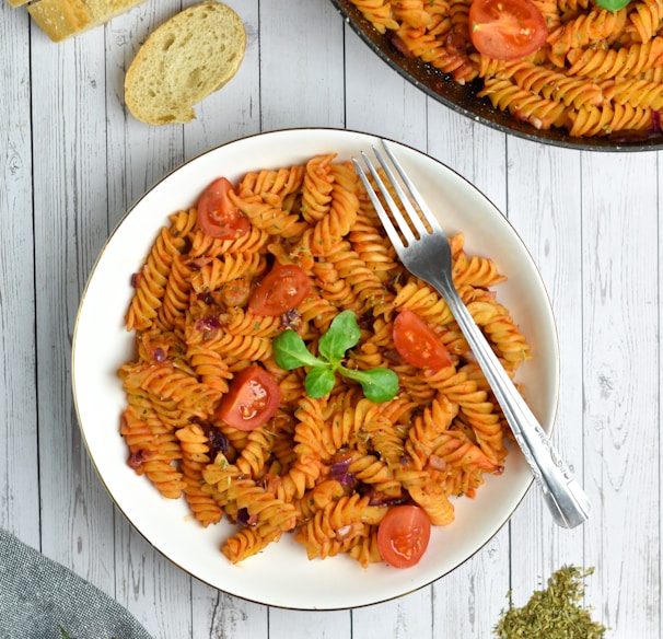 pasta with sauce on white ceramic plate