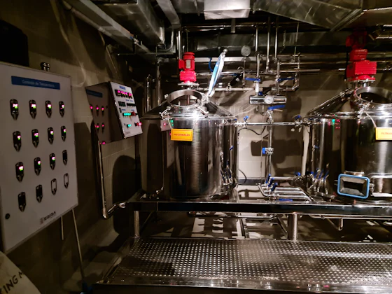 Stainless steel beer brewing tanks in a production room